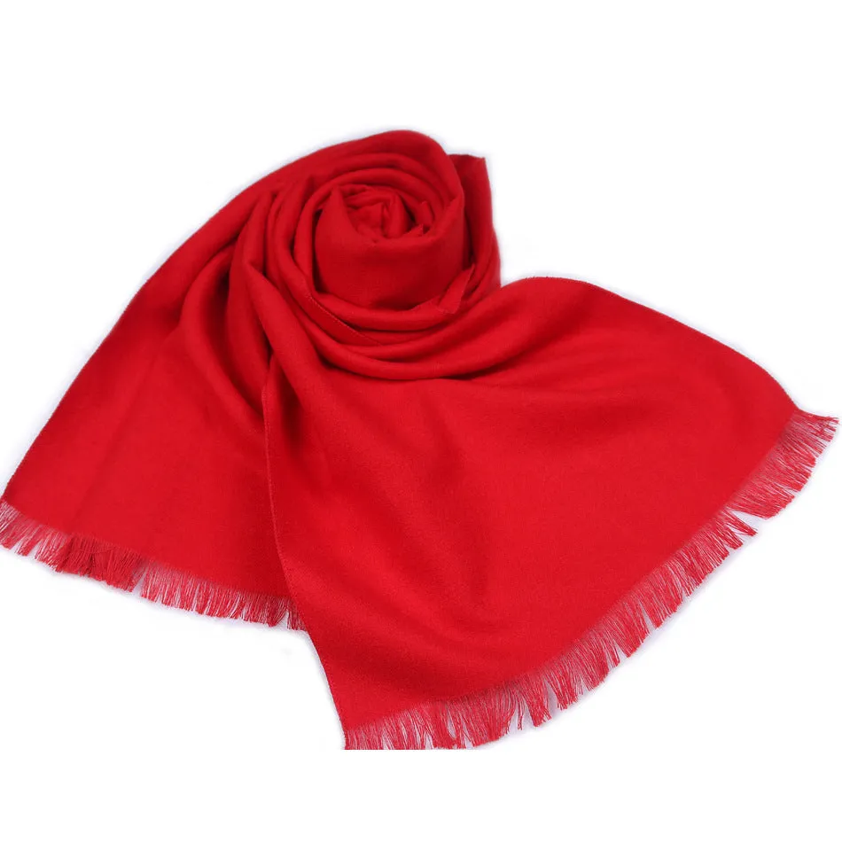 Men's solid red double-sided velvet scarf with tassel ends on a neutral background
