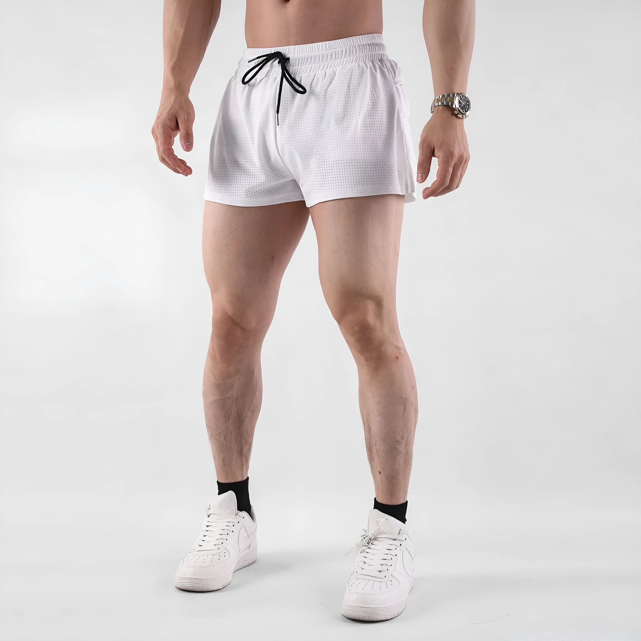 Men's quick-drying nylon shorts in black on a white background, showing mid-waist and short length.