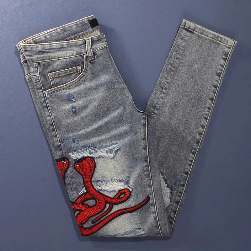 Men's slim fit jeans with embroidered patches and worn wash effect in old colour