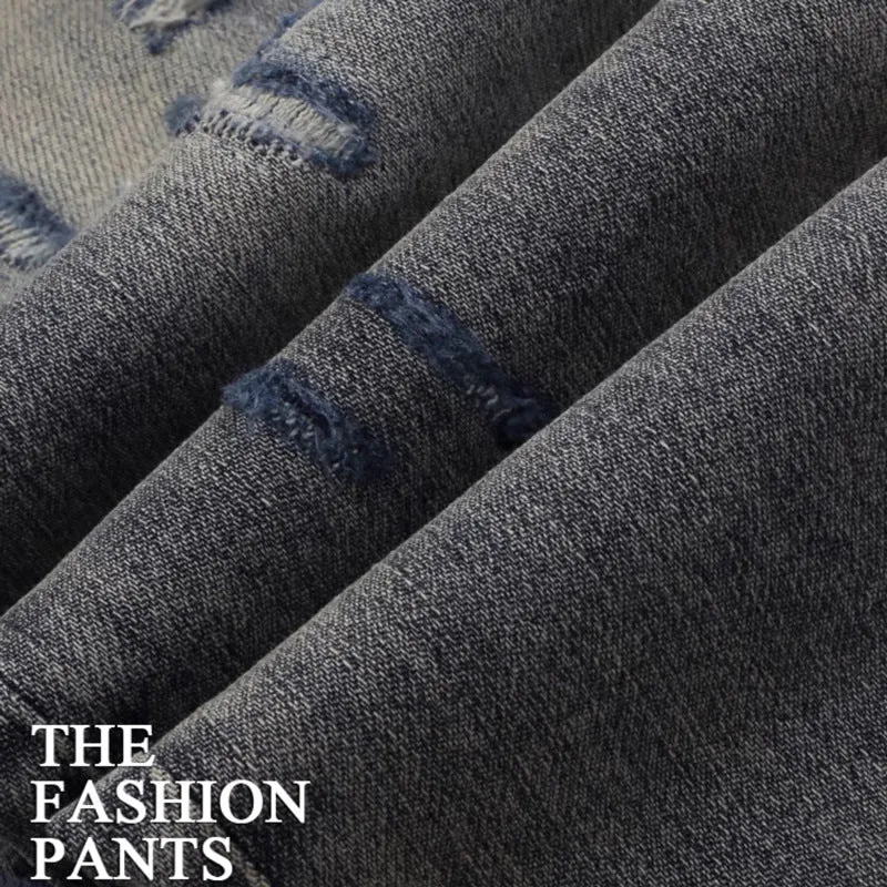 Men's slim fit jeans with embroidered patches and worn wash effect in old colour