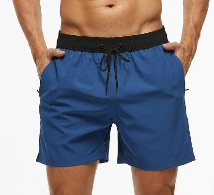 Men's blue stitching waist training shorts with zipper pockets and a drawstring, laid flat.