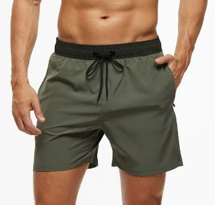 Men's blue stitching waist training shorts with zipper pockets and a drawstring, laid flat.