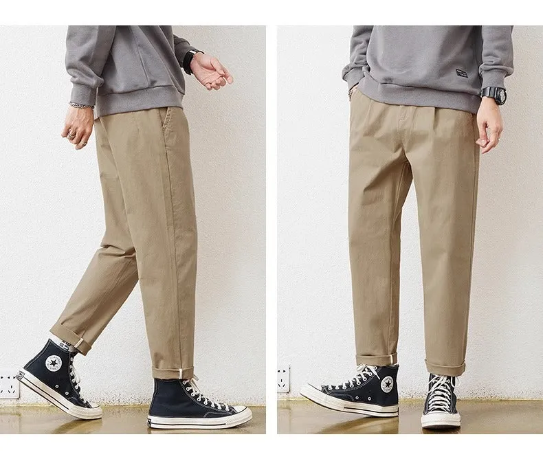 Men's loose wide-leg casual pants in dark khaki with zipper fly and mid-rise waist on a plain background