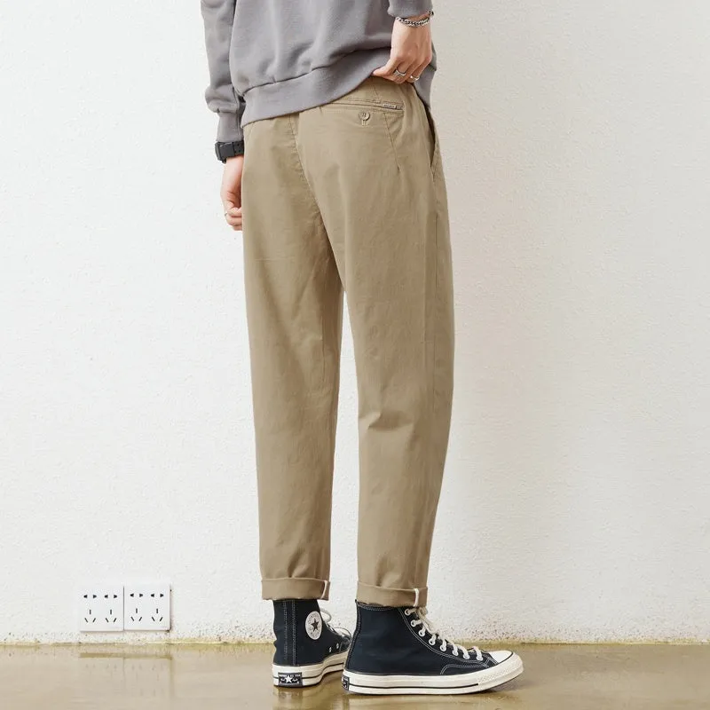 Men's loose wide-leg casual pants in dark khaki with zipper fly and mid-rise waist on a plain background