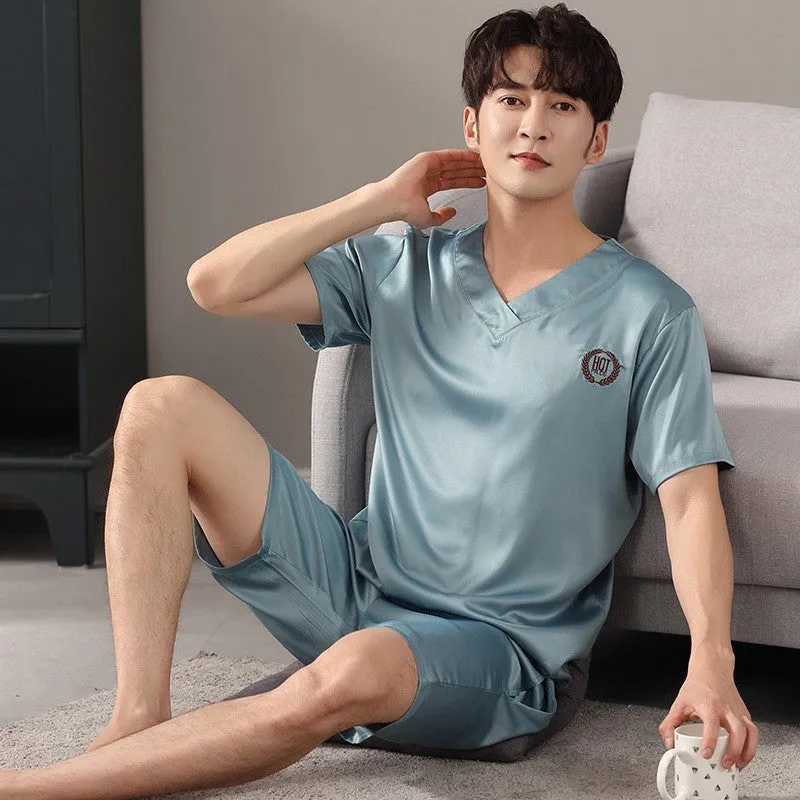 Man's loose-fitting ice silk pyjama set with short-sleeved shirt and shorts in a solid colour.