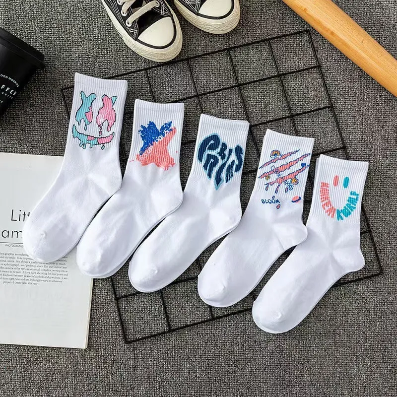 White cotton tube socks with graffiti pattern and middle calf length on plain background