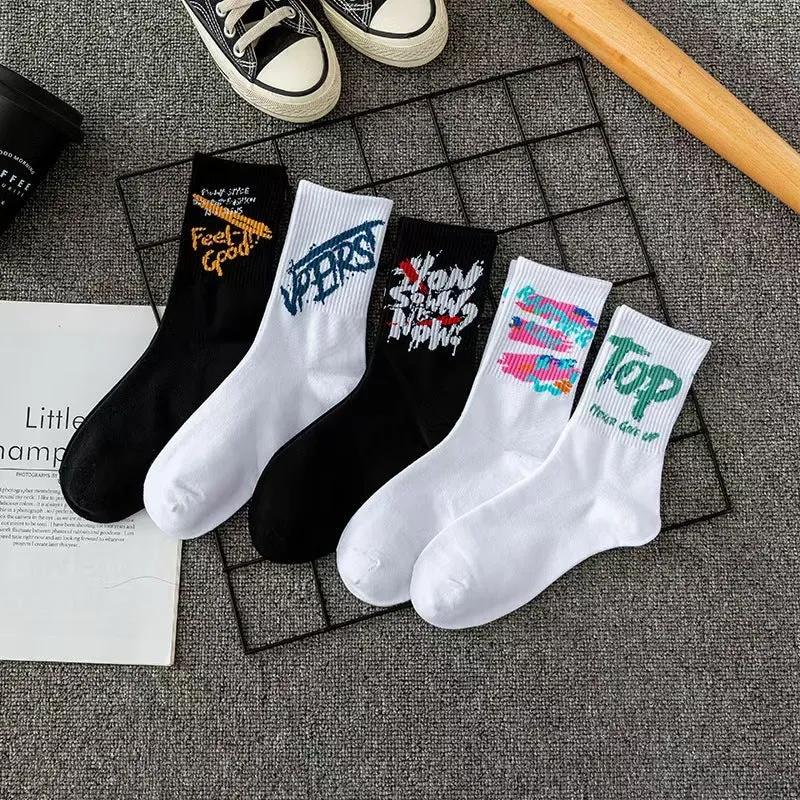 White cotton tube socks with graffiti pattern and middle calf length on plain background