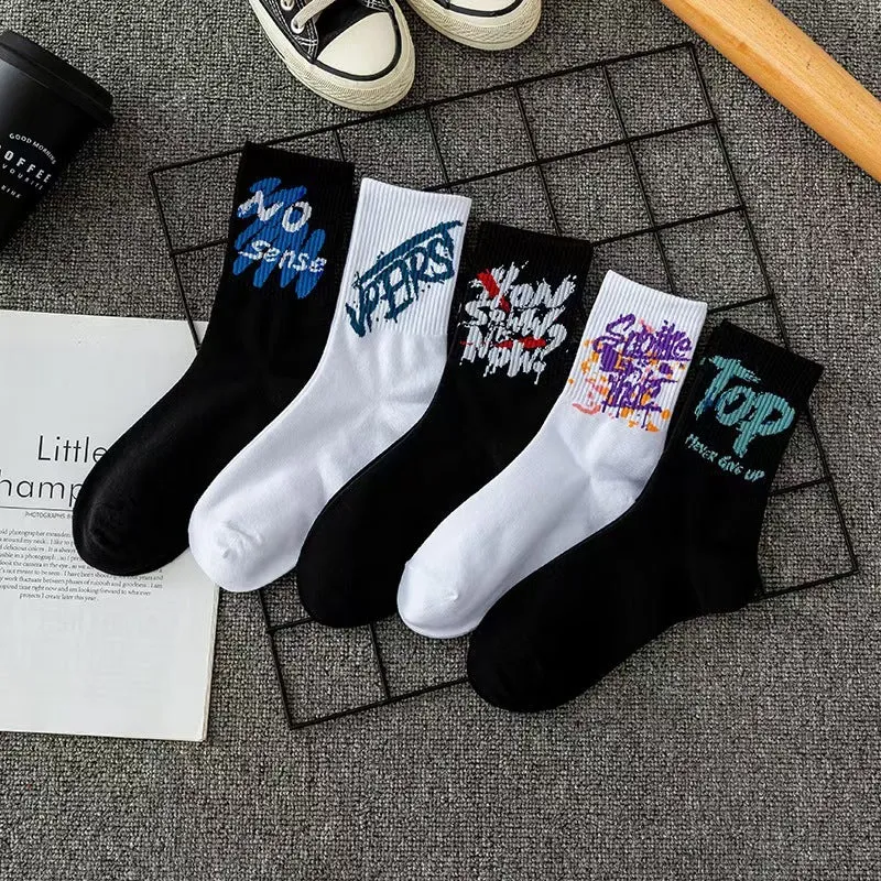 White cotton tube socks with graffiti pattern and middle calf length on plain background