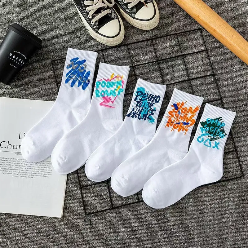 White cotton tube socks with graffiti pattern and middle calf length on plain background