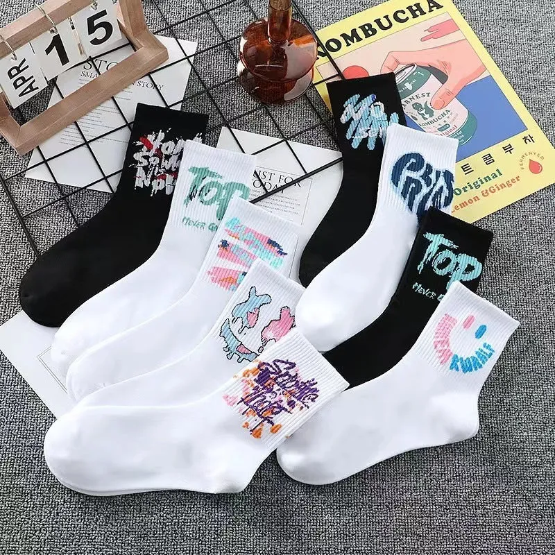 White cotton tube socks with graffiti pattern and middle calf length on plain background