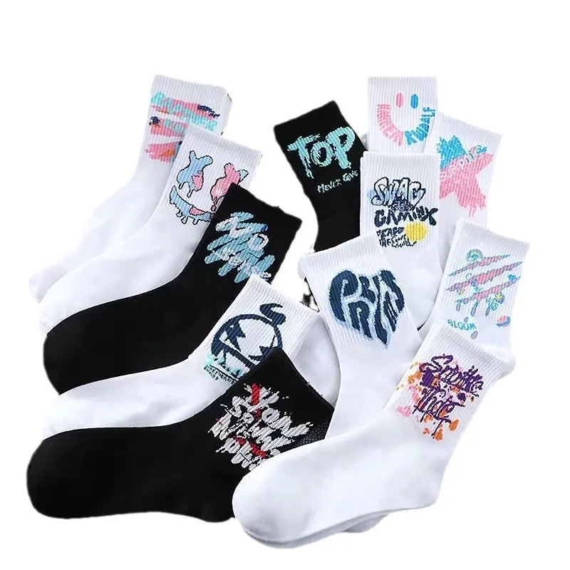 White cotton tube socks with graffiti pattern and middle calf length on plain background