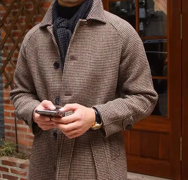 Mid-length brown wool coat with shoulder insert on a hanger, leisure style with structured shoulders