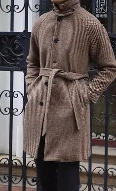 Mid-length brown wool coat with shoulder insert on a hanger, leisure style with structured shoulders