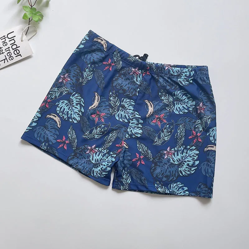 Men's loose-fit polyester swim trunks in dark blue with large flower print, three sizes available