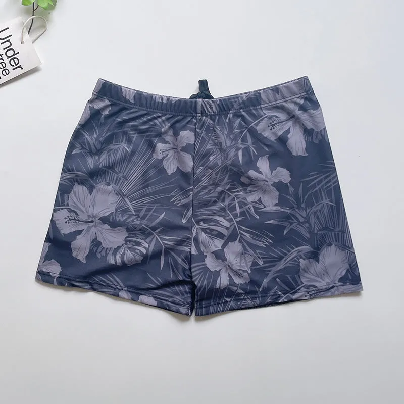 Men's loose-fit polyester swim trunks in dark blue with large flower print, three sizes available