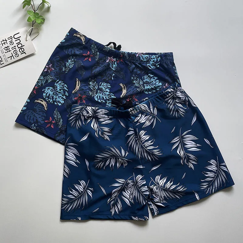 Men's loose-fit polyester swim trunks in dark blue with large flower print, three sizes available
