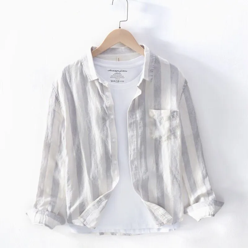 Blue long sleeve Hong Kong style loose fit men's casual shirt on a hanger.