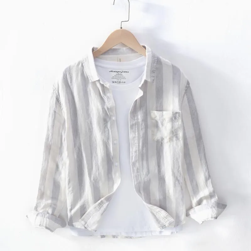 Blue long sleeve Hong Kong style loose fit men's casual shirt on a hanger.