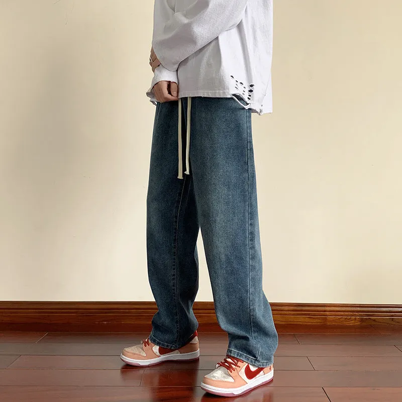 Men's loose cotton sports jeans in retro blue with zipper fly, side view on model