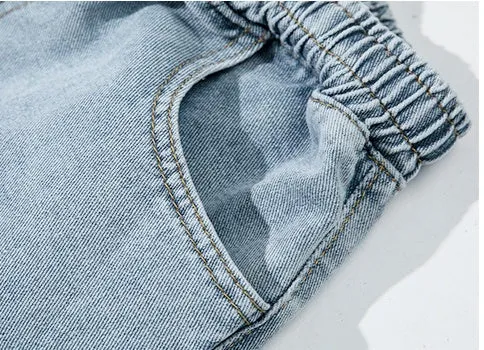 Men's loose cotton sports jeans in retro blue with zipper fly, side view on model