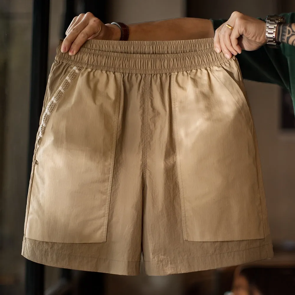 Madden Workwear Mountain quick-drying khaki shorts for men, straight-leg with large pocket, on model outdoors