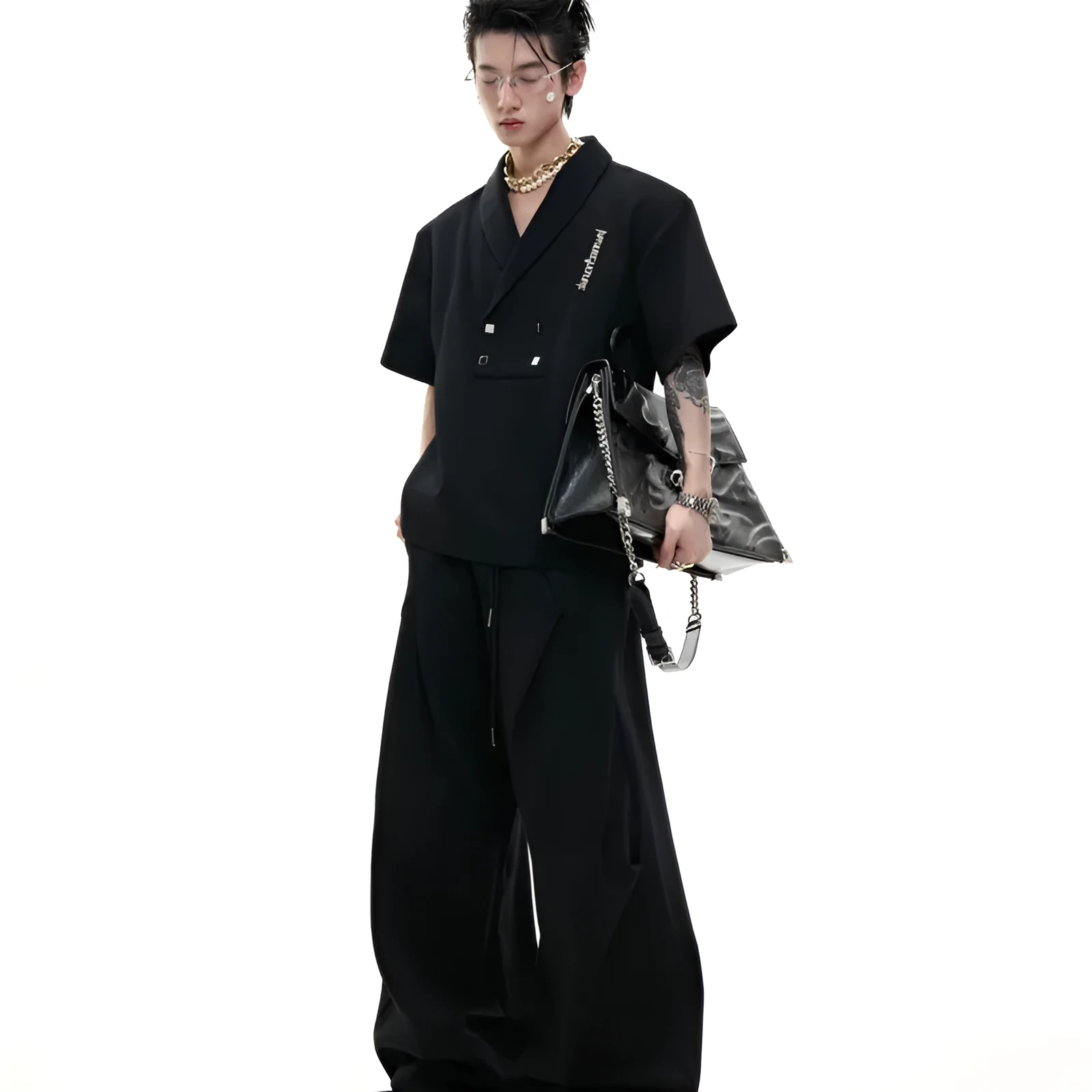 Men's dark grey V-neck short sleeve cotton sports jacket with padded shoulders and metal details, paired with matching shorts.
