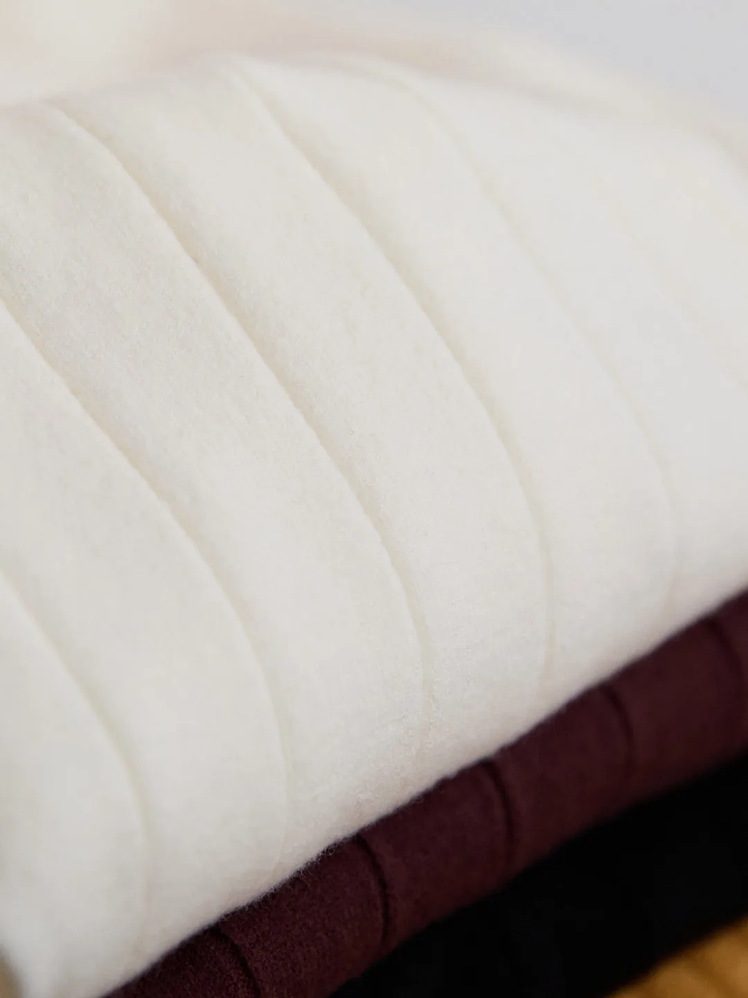 Half turtleneck wool blend knitted short sleeve T-shirt in chocolate colour, front view, on white background.