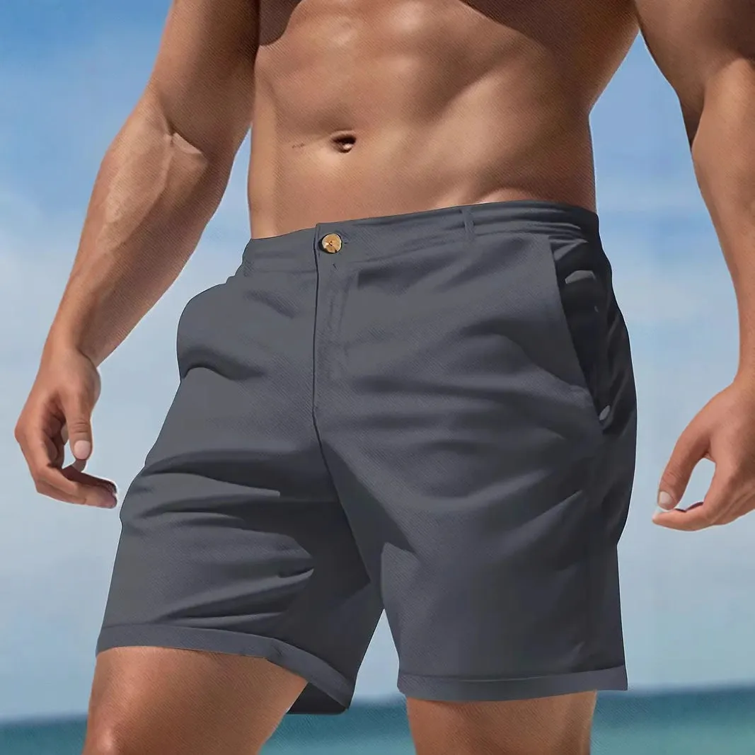 Man wearing grey straight-leg casual cotton blend sports shorts on a neutral background.