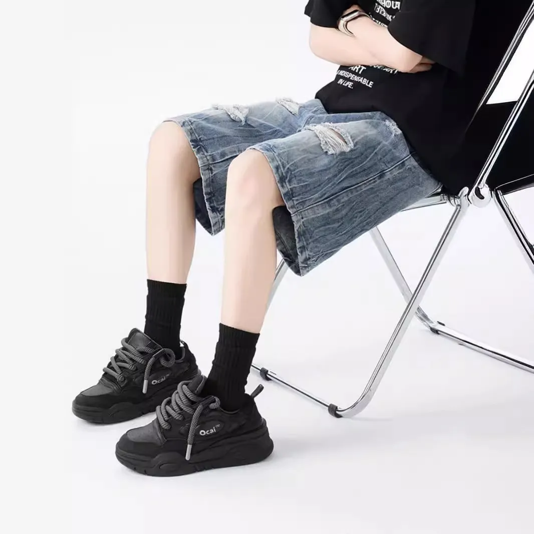Retro loose-fit ripped denim shorts in washed black or blue with distressed detailing