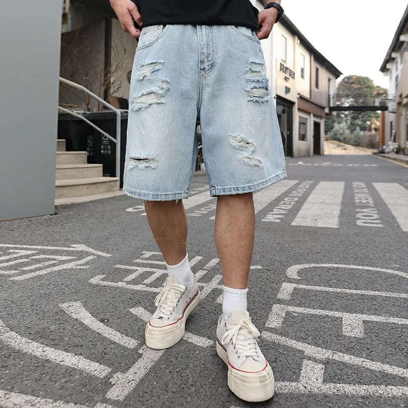 Men's light blue ripped denim shorts with a loose, straight leg fit on a plain background.