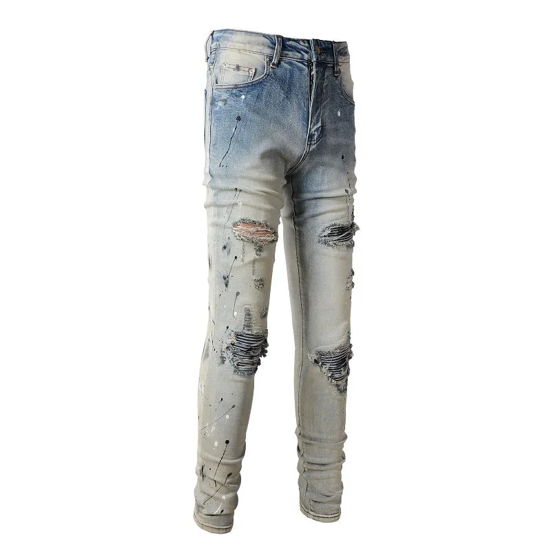 Men's blue light coloured paint splashing ink making old washed denim jeans with small straight leg and zip fly