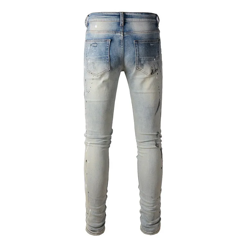 Men's blue light coloured paint splashing ink making old washed denim jeans with small straight leg and zip fly