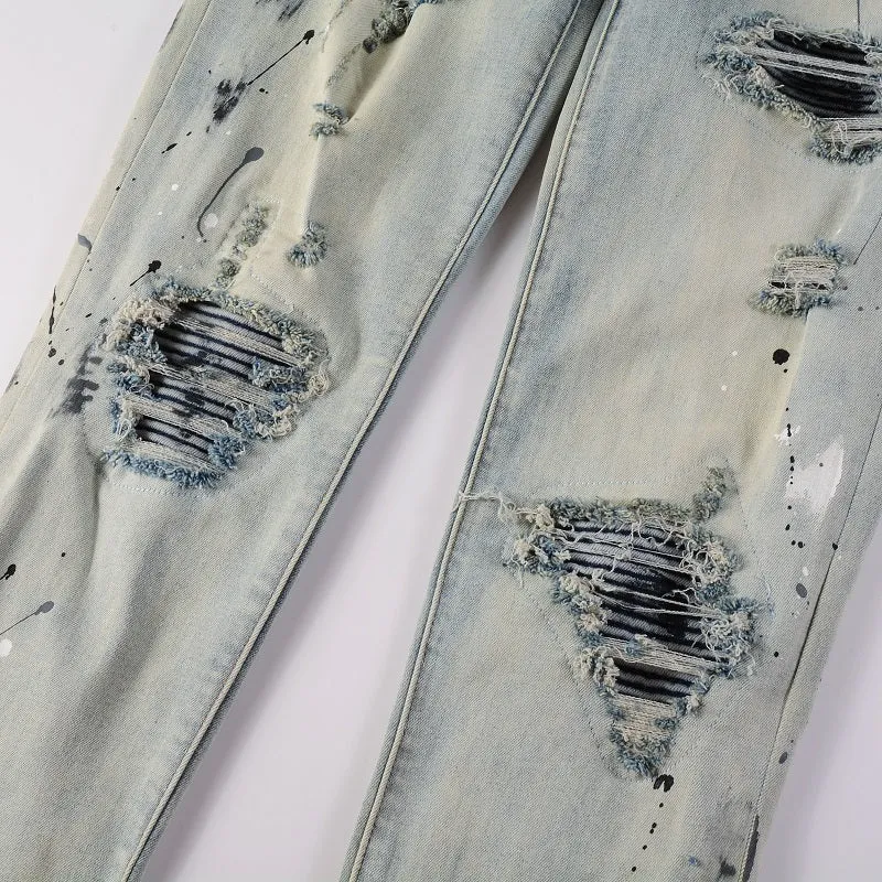 Men's blue light coloured paint splashing ink making old washed denim jeans with small straight leg and zip fly