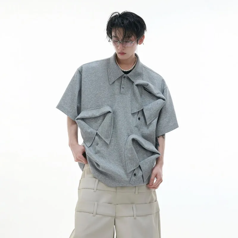 Men's black geometric print polo shirt with a deconstructed layered collar design.