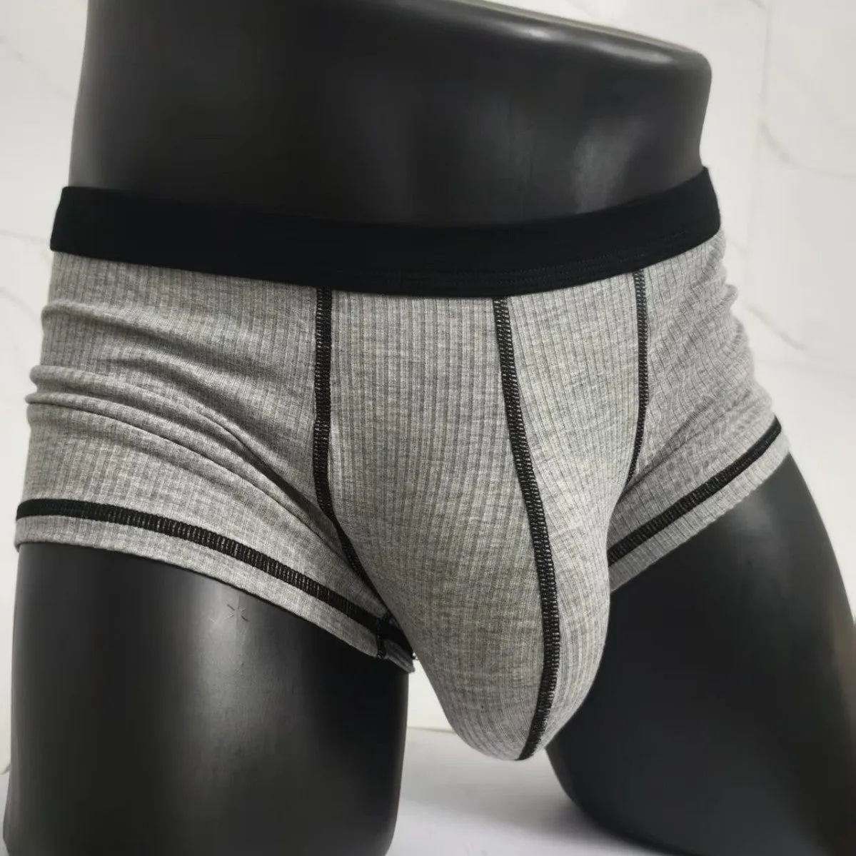 Men's solid colour breathable boxer shorts in Army Green, shown laid flat to display thin fabric and cut.