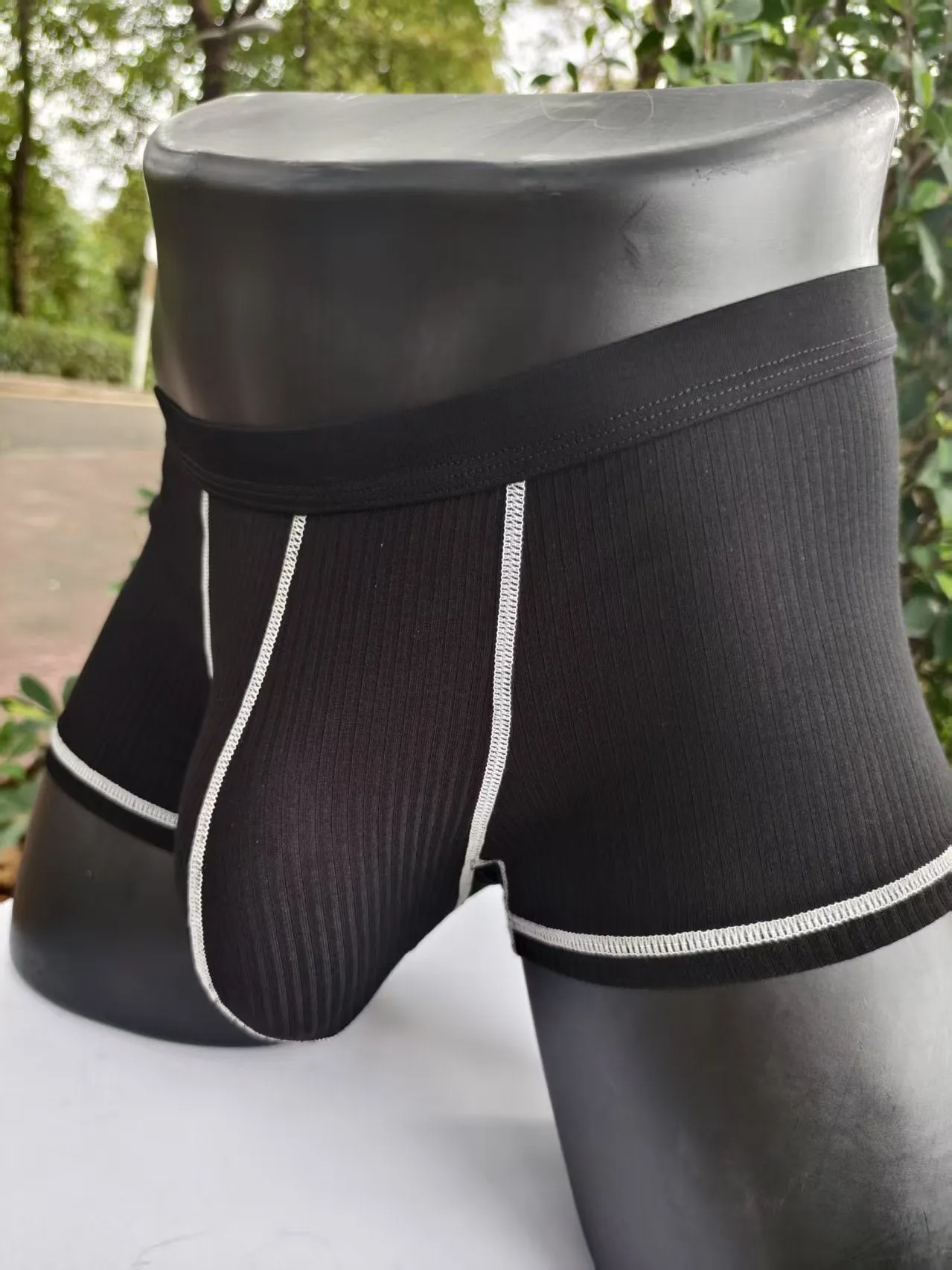 Men's solid colour breathable boxer shorts in Army Green, shown laid flat to display thin fabric and cut.