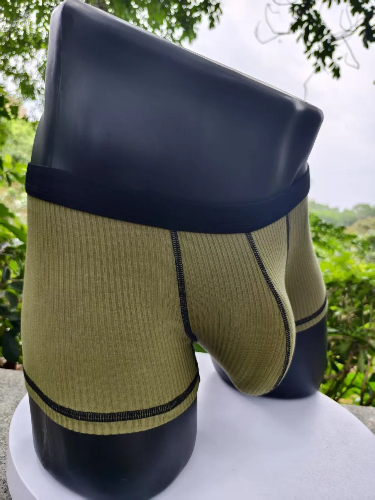 Men's solid colour breathable boxer shorts in Army Green, shown laid flat to display thin fabric and cut.
