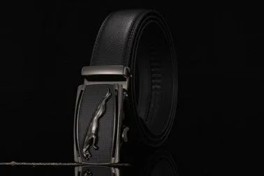 Men's two-layer cowhide belt with gold alloy automatic buckle on a flat surface