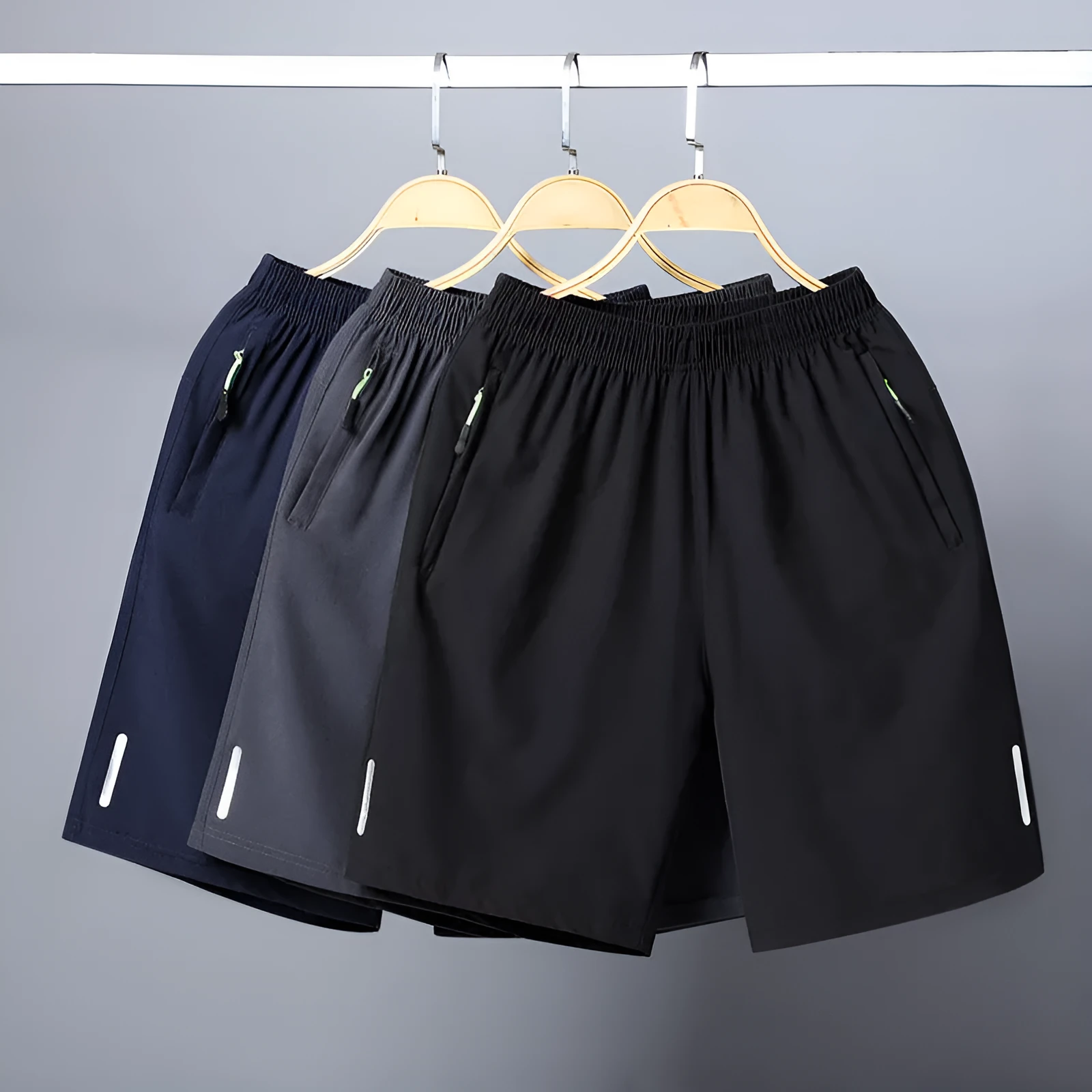 Men's polyester solid colour beach casual sports shorts with zippered pocket in black, gray, and blue