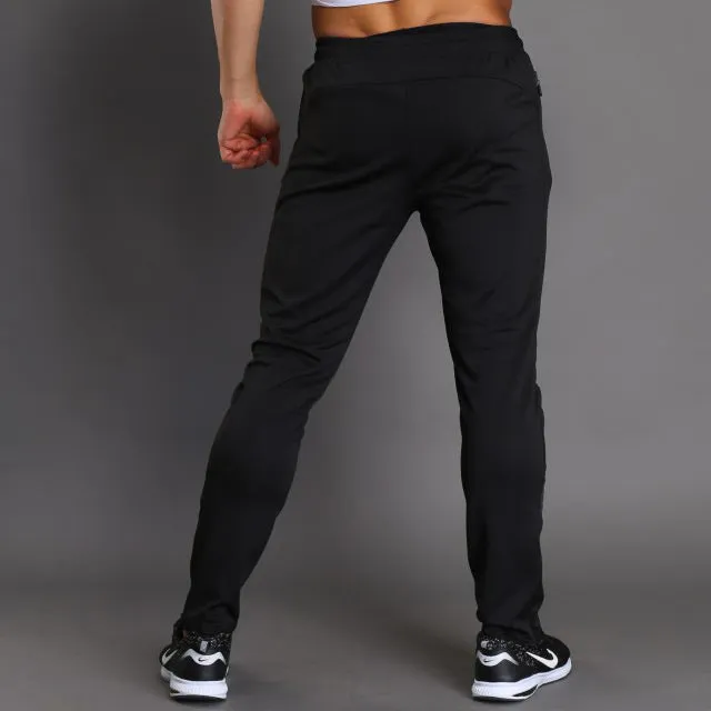 Black running fitness trousers with colour-changing reflective print, slim fit, zippered pockets, polyester fabric