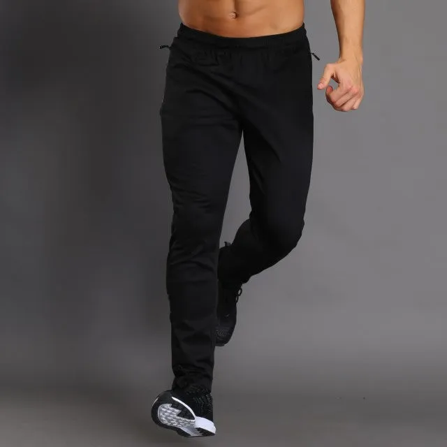 Black running fitness trousers with colour-changing reflective print, slim fit, zippered pockets, polyester fabric