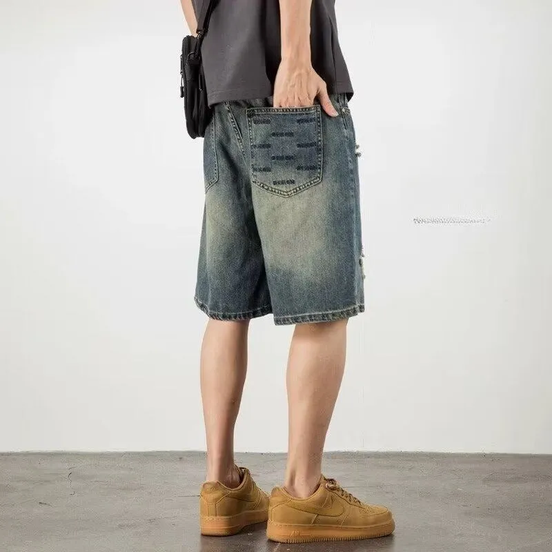 Blue retro-style men's denim shorts with a straight leg and slight distressing details on a neutral background.