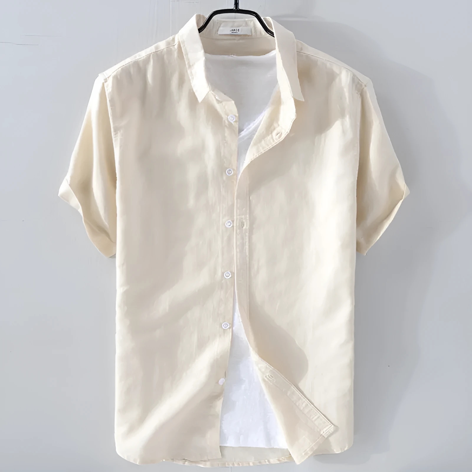 Men's solid colour short sleeve linen blend shirt on a hanger, showing loose fit.