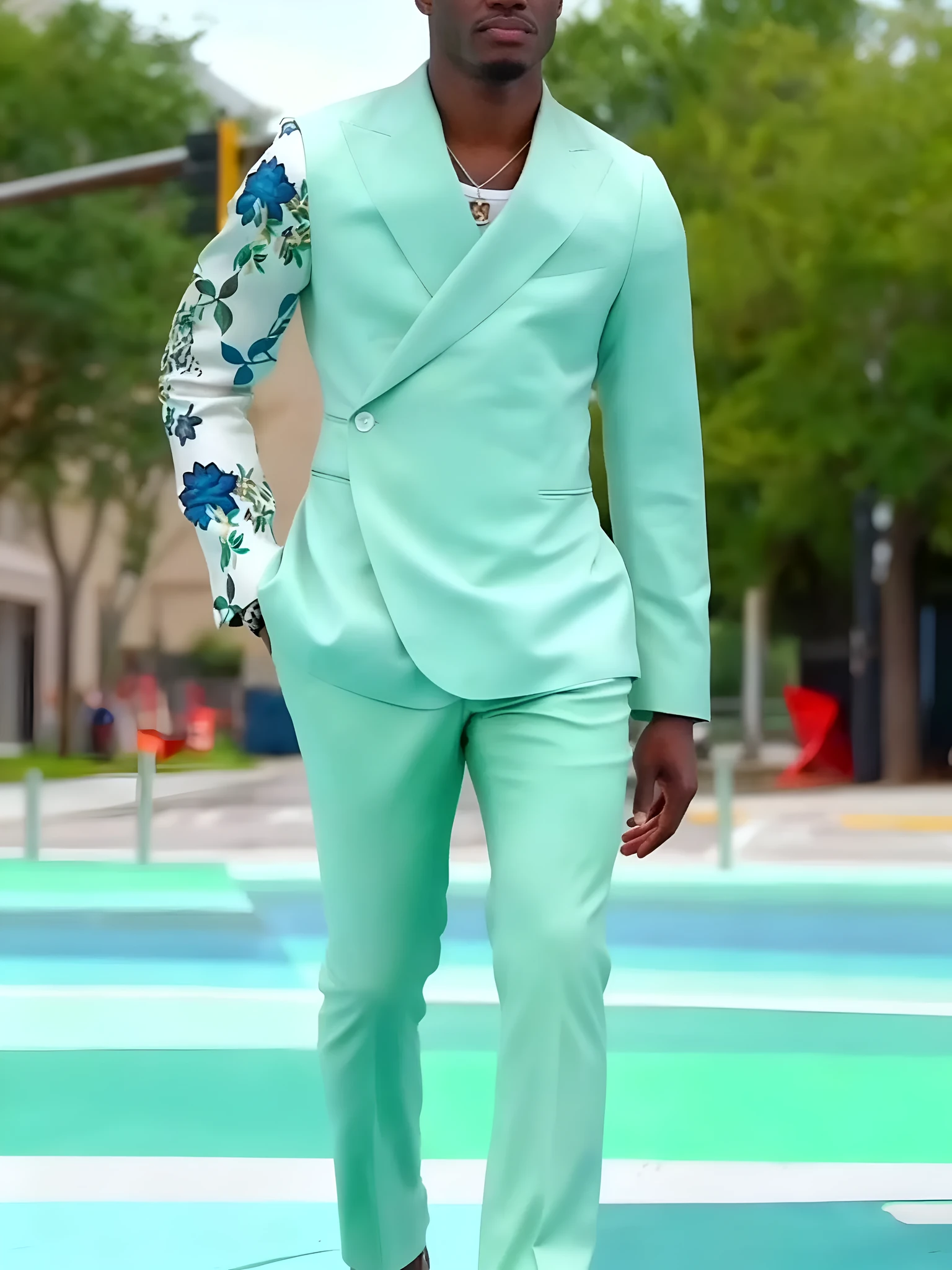 Mint green women's suit with double-breasted blazer and floral print sleeves, paired with ankle-length pants