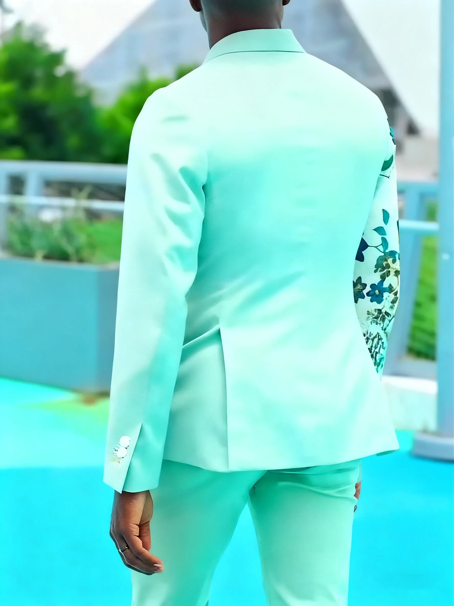 Mint green women's suit with double-breasted blazer and floral print sleeves, paired with ankle-length pants