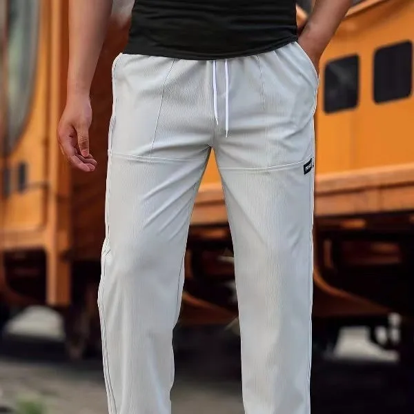 Men's light grey polyester trousers for spring and autumn wear, laid flat.