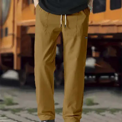 Men's light grey polyester trousers for spring and autumn wear, laid flat.
