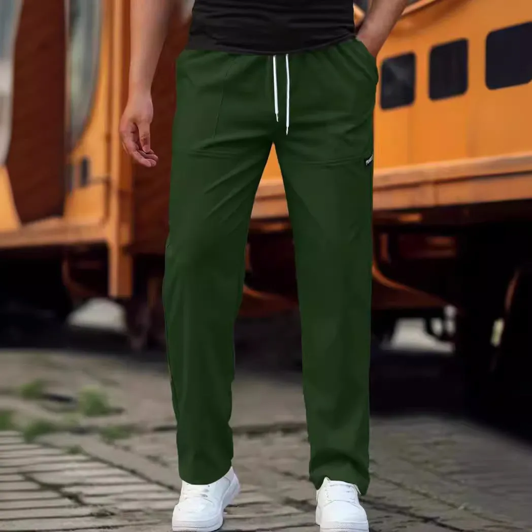 Men's light grey polyester trousers for spring and autumn wear, laid flat.