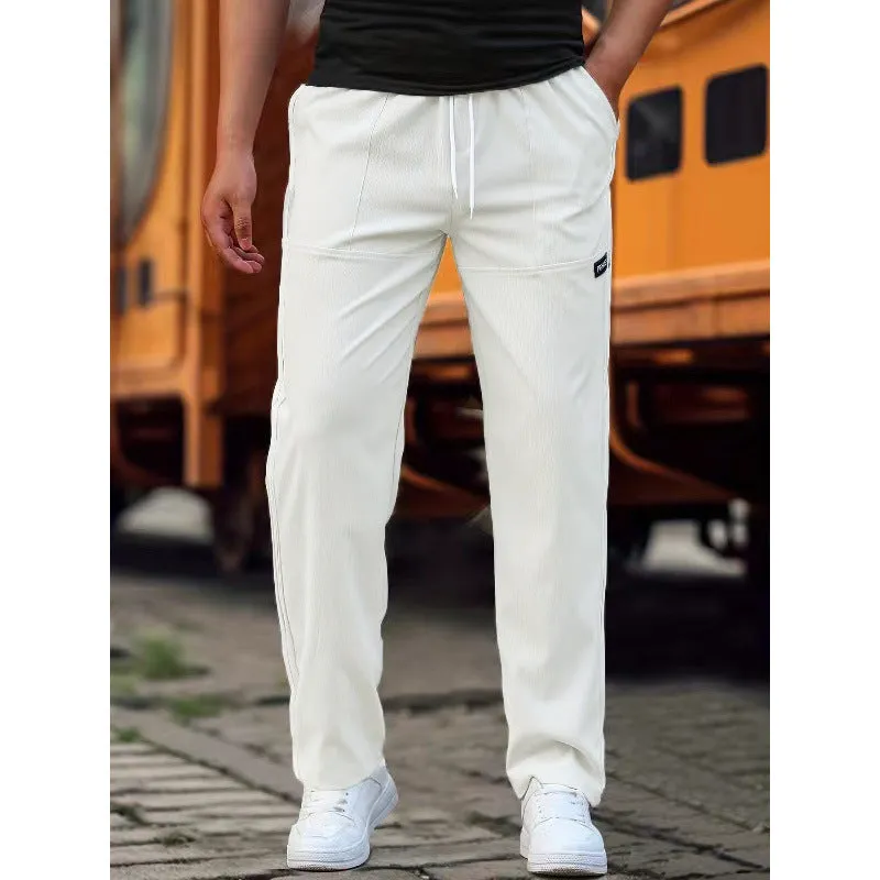 Men's light grey polyester trousers for spring and autumn wear, laid flat.