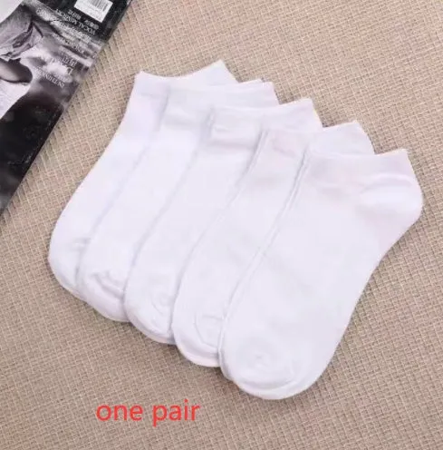Black, white, and grey boat socks and medium tube socks from Degner in cotton blend fabric